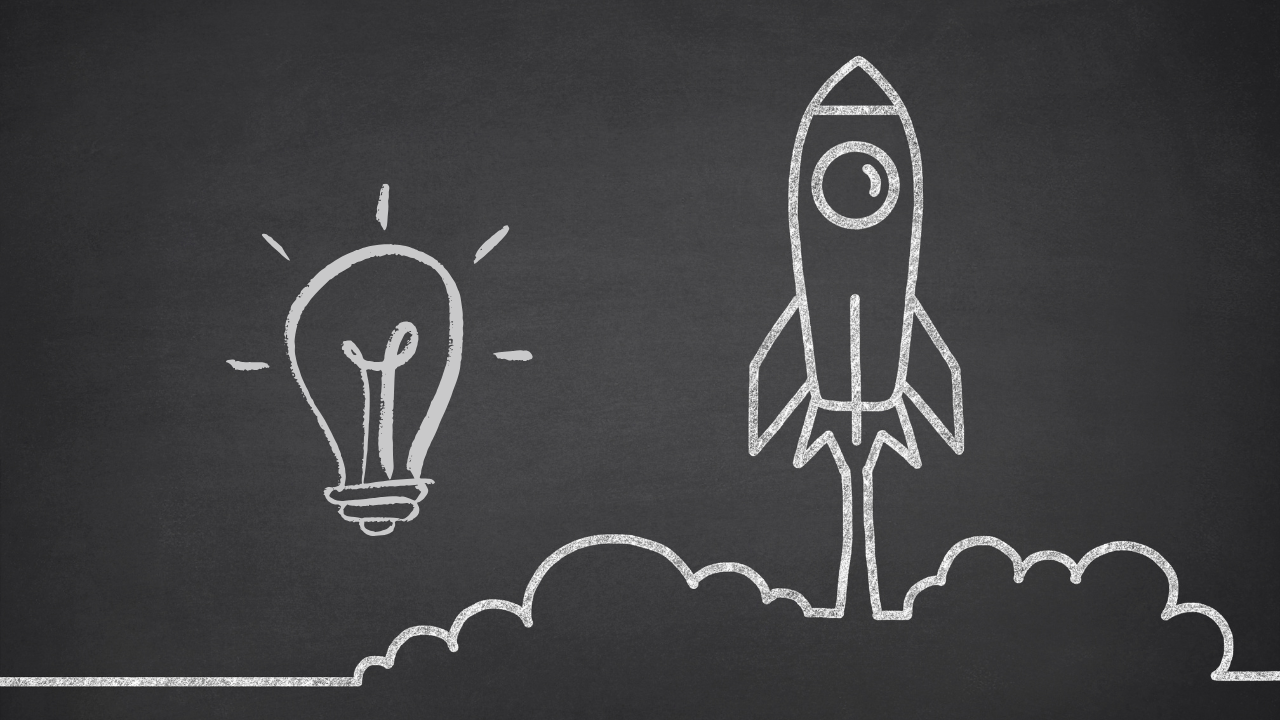 A white chalk drawing of a lightbulb and a launching rocket ship on a black chalkboard, representing Startup Business Essentials: A Proven Roadmap for Modern Founders.